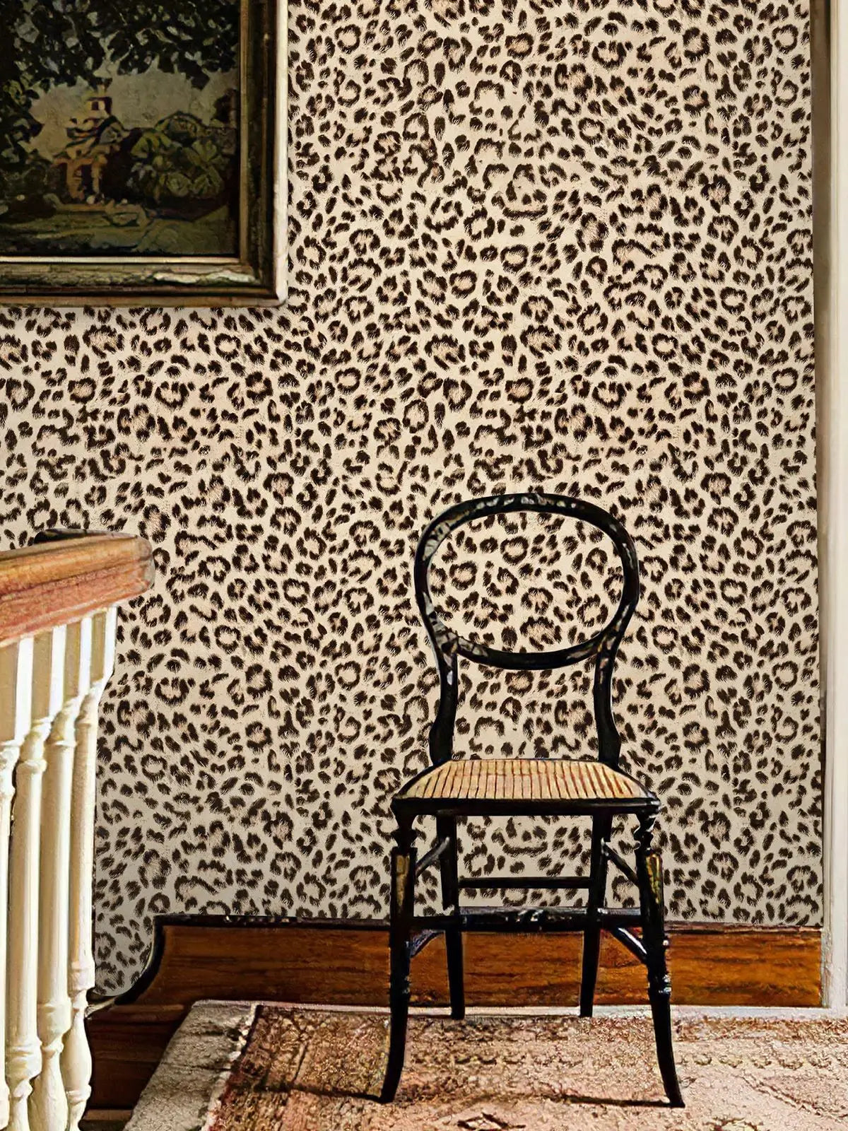 A vintage wooden chair is placed in front of a wall covered with retro leopard print wallpaper.