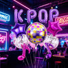 A cluster of purple and pink foil balloons shaped like letters and stars for a party decoration.