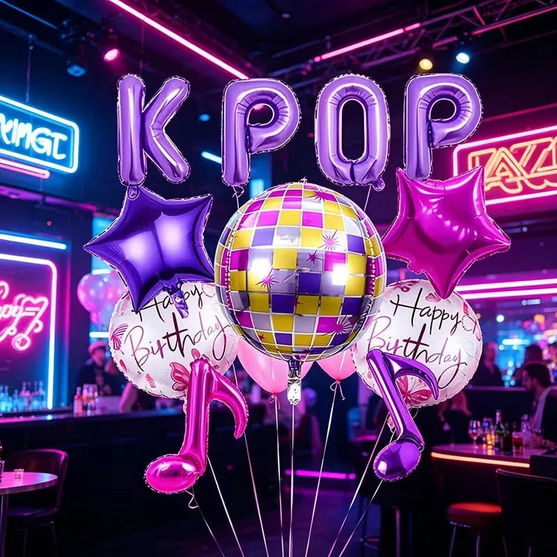 A cluster of purple and pink foil balloons shaped like letters and stars for a party decoration.