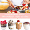 A set of six elegant mini dessert cups with spoons filled with fruit and cream