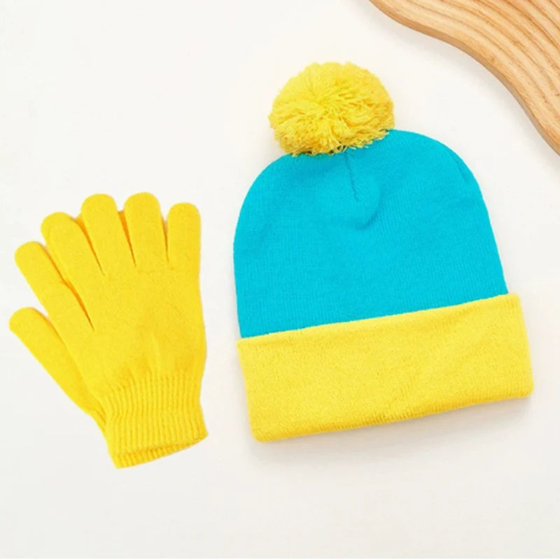 A set of knitted winter accessories featuring a bright blue pom-pom beanie and matching yellow gloves.