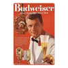 A man holds a glass of beer while a vintage beer metal sign set is displayed in the foreground.