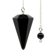 A black natural stone teardrop pendulum with a silver chain for divination and energy healing