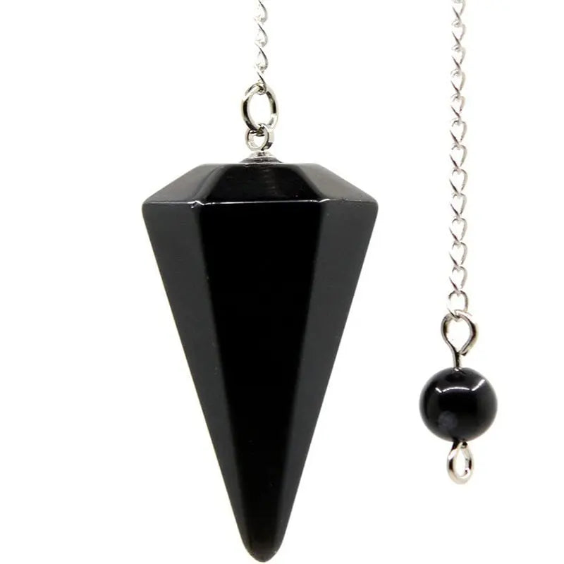 A black natural stone teardrop pendulum with a silver chain for divination and energy healing