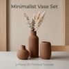 A set of three matte ceramic vases with vertical ribbed texture and dried floral stems displayed on a light surface.