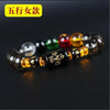 A bracelet made of various colored crystals, including black, green, red, and yellow, displayed on a dark background.