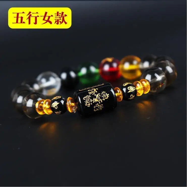 A bracelet made of various colored crystals, including black, green, red, and yellow, displayed on a dark background.