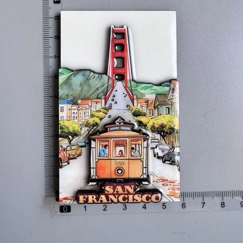 A collection of wooden fridge magnets featuring a cityscape with buildings and a prominent red tower, labeled San Francisco.