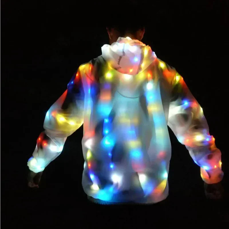 A person wearing a light-up neon costume jacket with colorful LED lights against a dark background.