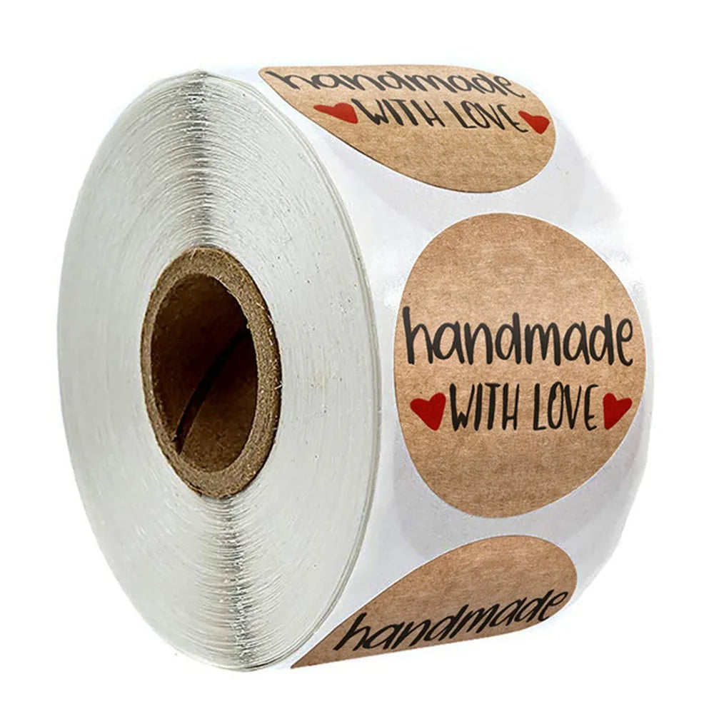 Roll of kraft paper thank you stickers with handwritten text and heart accents