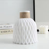 White plastic vase with a woven straw lid and a ripple texture, used as modern Nordic style desktop decor.