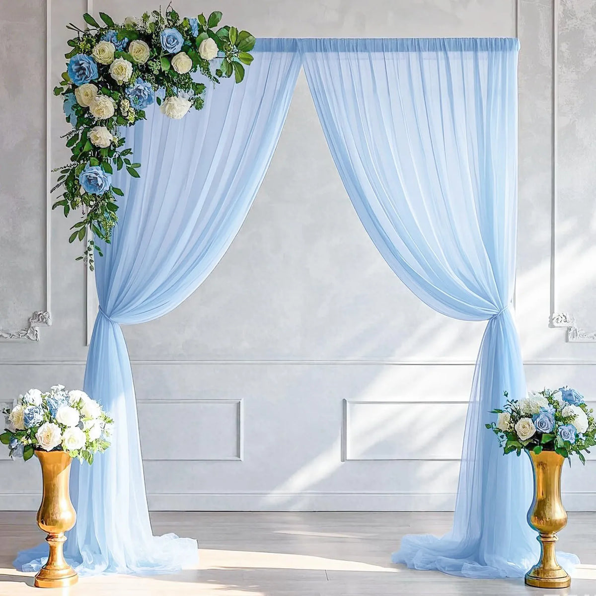 Light blue chiffon backdrop curtain draped elegantly for a wedding or event setting.