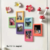 A collection of colorful retro magnetic photo frames featuring various photographs and floral decorations.