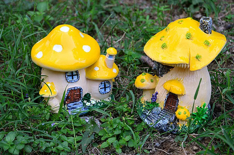 A yellow resin mushroom house garden statue with a large cap and small windows nestled in green grass.
