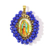 A pendant set featuring a small statue of the Virgin Mary surrounded by blue beads and gold findings.