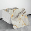 A sheet of white marble tile sticker featuring gold veining and natural gray marble patterns.