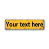A rectangular vintage yellow tin sign with black text that reads Your text here.