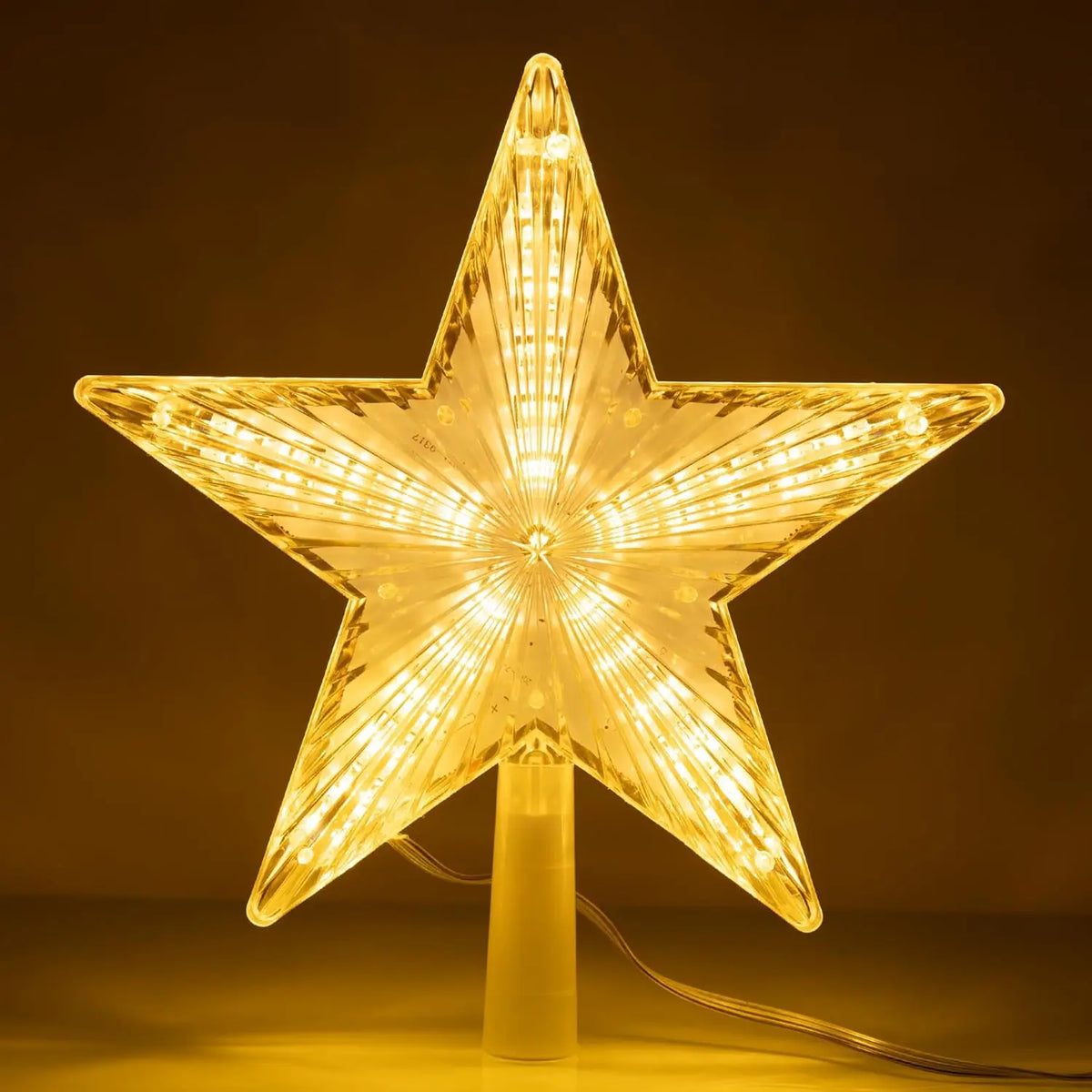 A glowing LED star shaped light fixture with a pointed design on a stand.