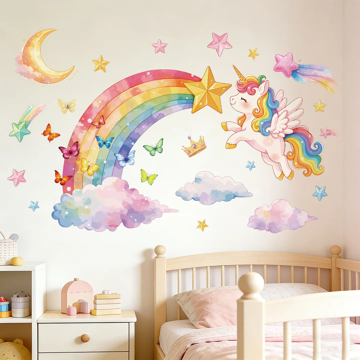 A wall decal featuring a magical unicorn and rainbow arch over fluffy clouds on a white wall.
