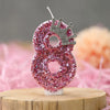 Pink sequin number eight candle with a silver crown topper