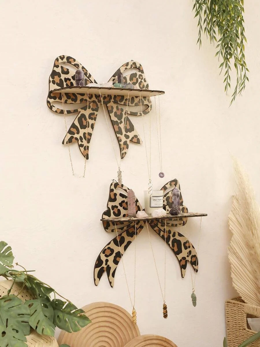 A wall mounted storage rack featuring leopard print decorative hooks and shelves.