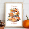 Framed canvas wall art featuring a seasonal arrangement of pumpkins and autumn foliage with the word welcome and october