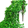 Artificial ivy vine garland cascading down a wooden plant stand for home decor