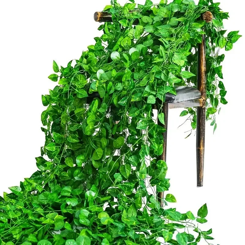 Artificial ivy vine garland cascading down a wooden plant stand for home decor