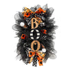 Halloween BOO wreath with pumpkin garland door hanging featuring black netting and orange and black patterned bows