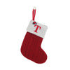 Red knitted sock with a white cuff featuring a red letter T for Christmas tree decor