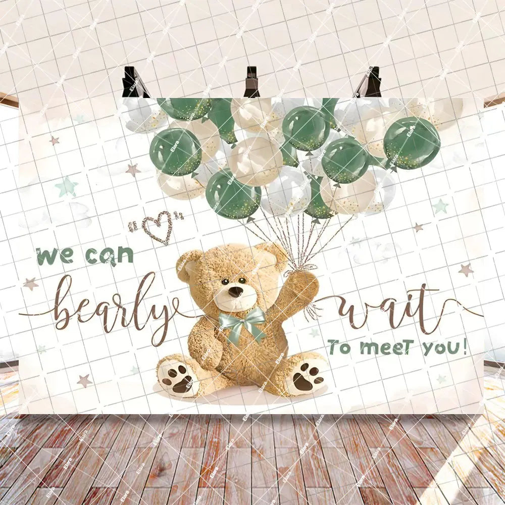 A gender reveal decoration set featuring a bear balloon banner with green and white balloons.