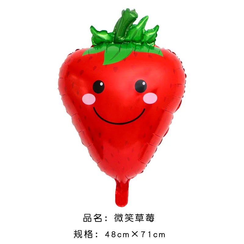 A bright red inflatable strawberry decoration used for summer celebrations.