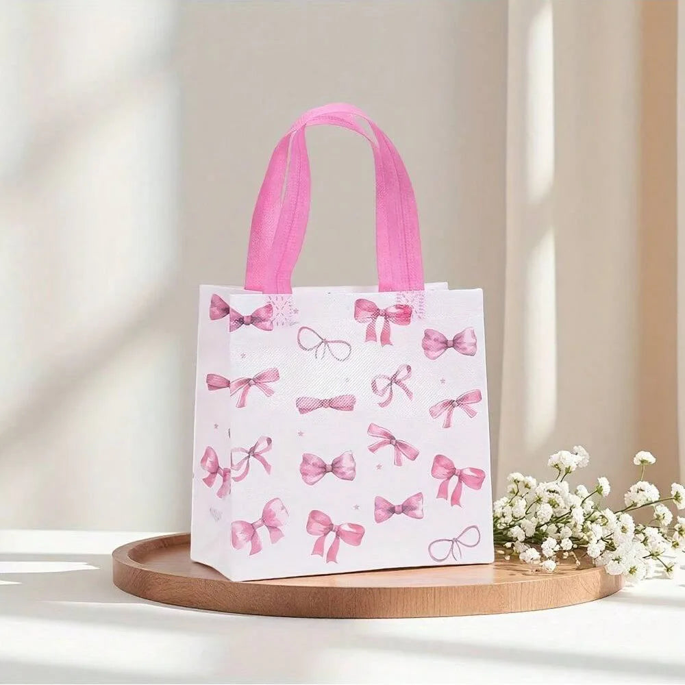 Pink and white bow gift bags with heart cutouts displayed on a wooden tray.