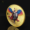A gold medal coin featuring a winged Archangel Michael figure with a sword and shield.