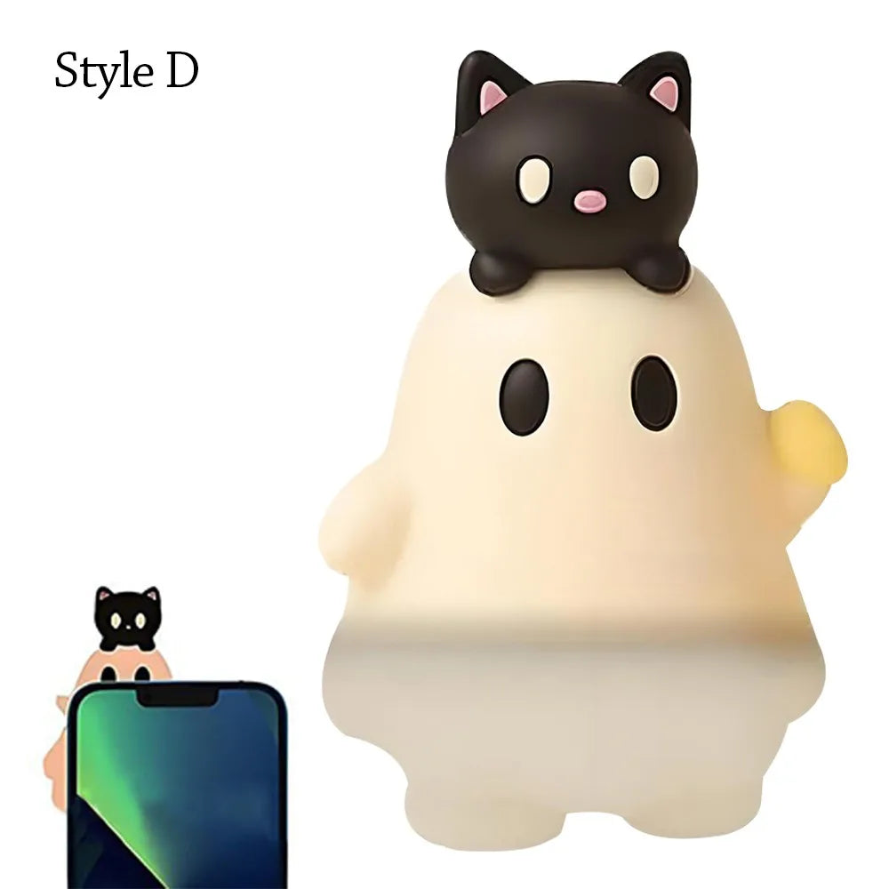 A cute black cat ghost phone decoration charm with a white body and yellow accents.