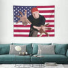A tapestry featuring a hand gesture against an American flag background.