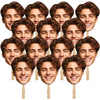 A collection of custom face photo props on sticks featuring young men's smiling faces.