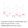A set of pink hanging spin bows used as disposable party tableware