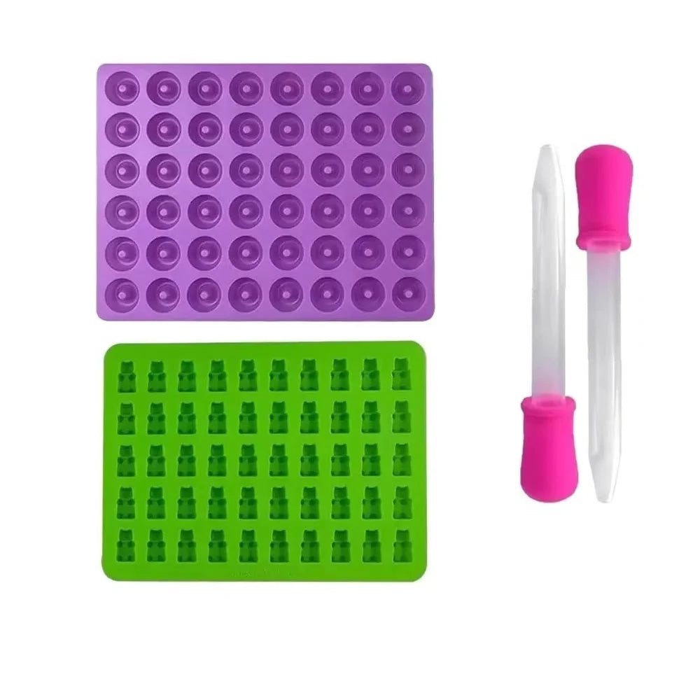 A set of purple and green silicone candy molds with droppers for DIY chocolates and jellies