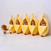 A row of adorable plush monkeys wearing yellow sleeping bags shaped like bananas.