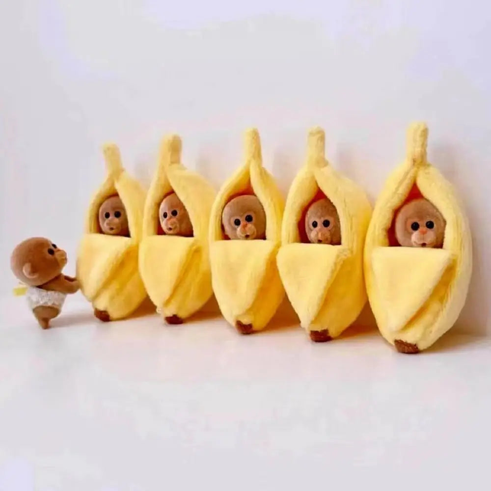 A row of adorable plush monkeys wearing yellow sleeping bags shaped like bananas.