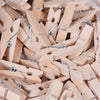 A pile of natural wooden mini clothespins with silver wire clips for crafts and decor.