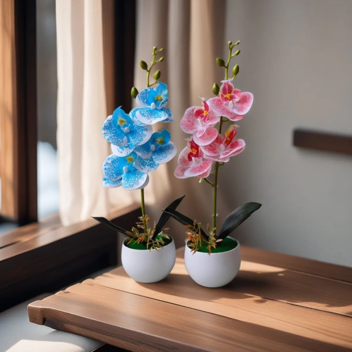 Two artificial orchid plants, one blue and one pink, are displayed in white pots on a wooden surface.