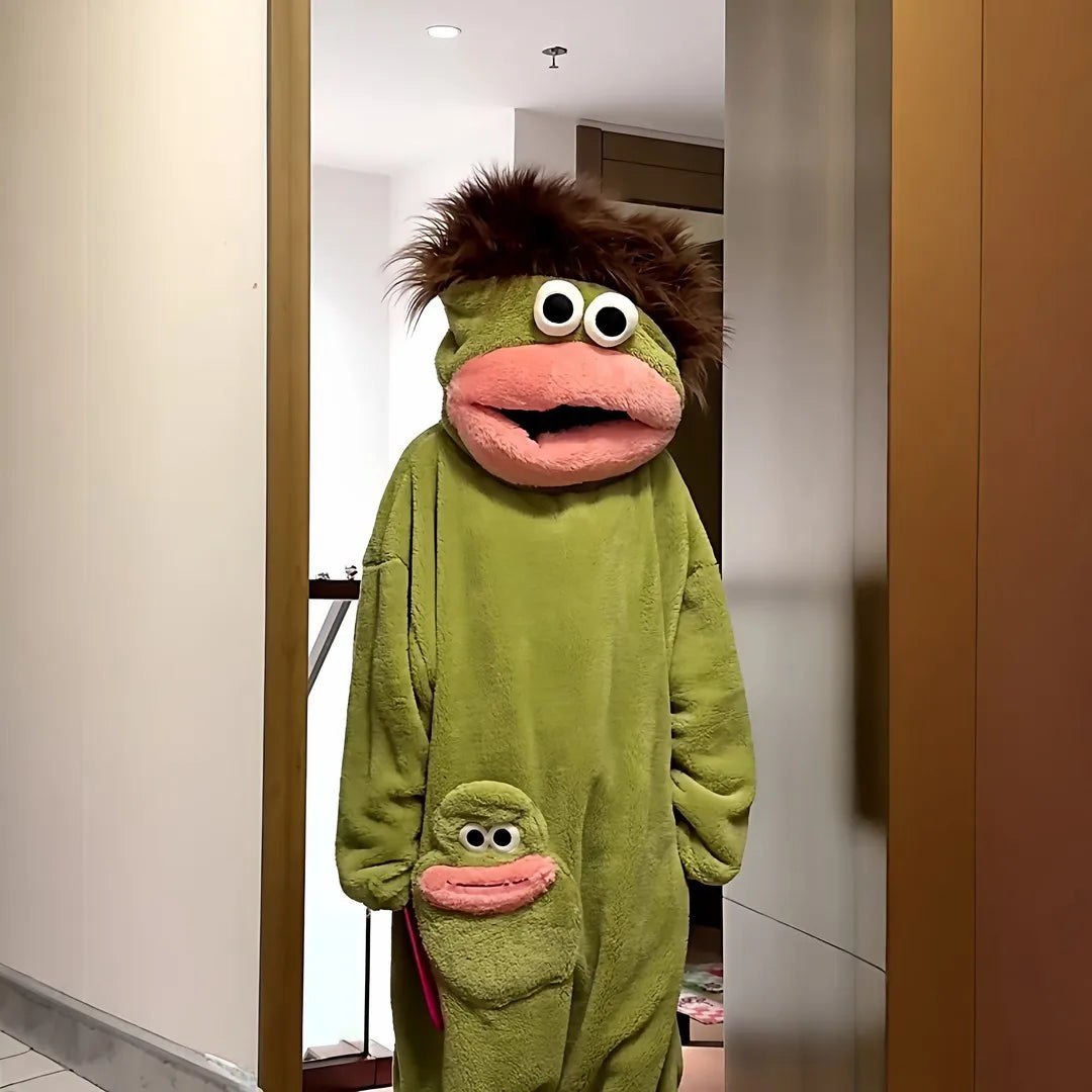 A person wearing a fuzzy, olive green monster onesie pajama suit.