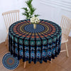 Bohemian peacock mandala round tablecloth displayed on a wooden table with chairs in a bright room.