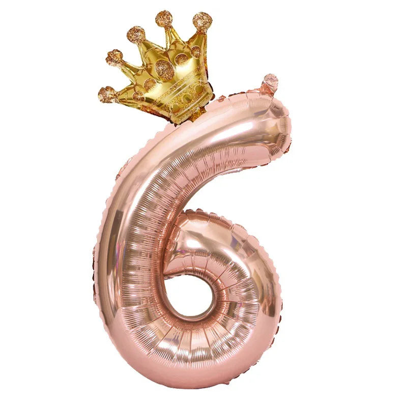 Rose gold foil balloon shaped like the number 6 with a gold crown on top