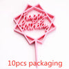 Pink acrylic hexagon shaped birthday sign with the words happy birthday and a stick for display