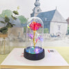 Rose en verre éternelle avec une floraison rouge vibrante et lumière LED lumineuse sur une base noire.