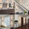 Modern bubble crystal LED wall sconces illuminating a luxurious bathroom vanity and staircase.