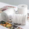 White braided cotton candle wicks displayed on spools and packaging.